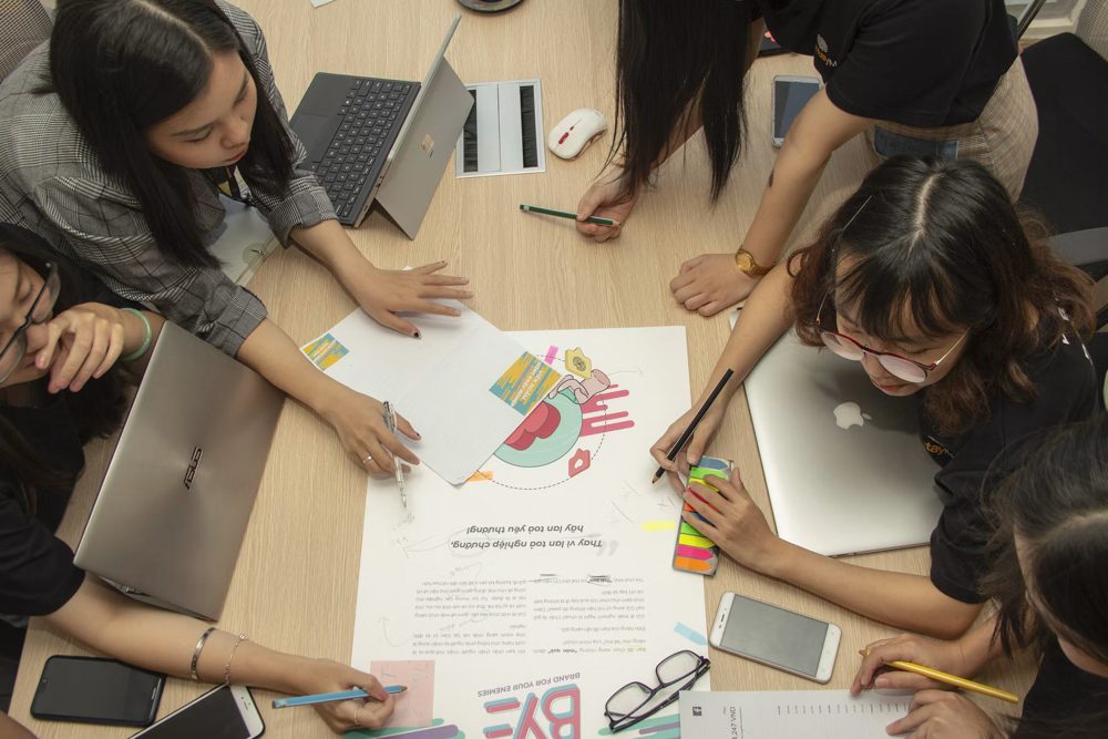 A team working over printed charts at a table