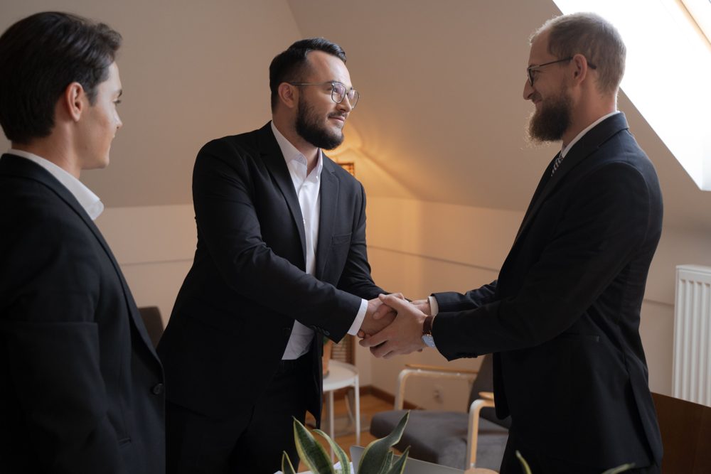Two business people shaking hands in a meeting